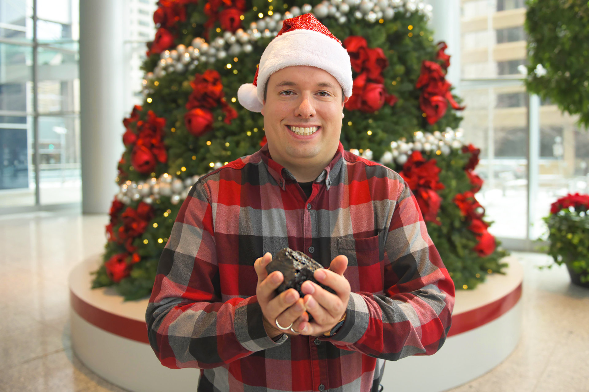 Tyler Wudrick, an inspector with the AER’s Coal & Dam Safety team, hefts a chunk of coal.