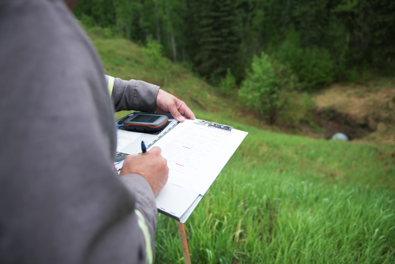 Inspector uses his GPS to track the coordinates of the exact location of each culvert