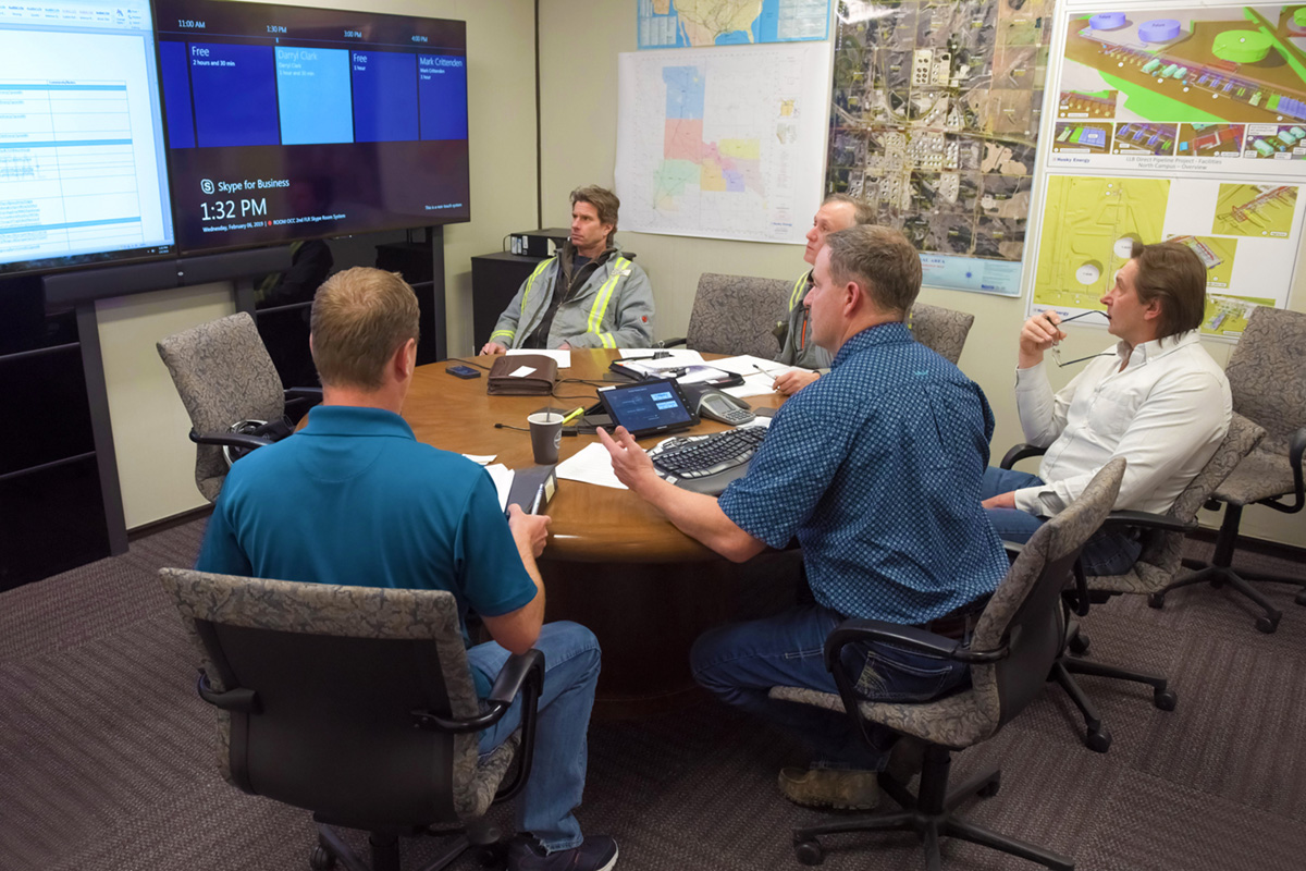 members of the Husky team review inspection reports with AER inspectors