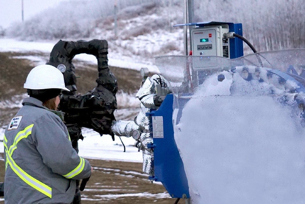 Alberta Energy Regulator inspector checking system during cold weather
