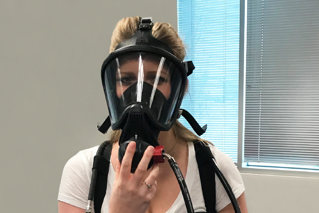 Woman donning Self-Contained Breathing Apparatus 
