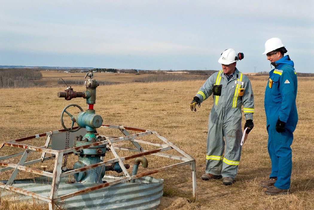 Men watching the well