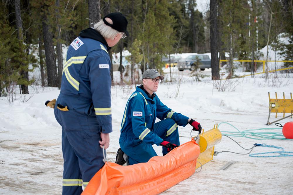 Inspectors with containment booms