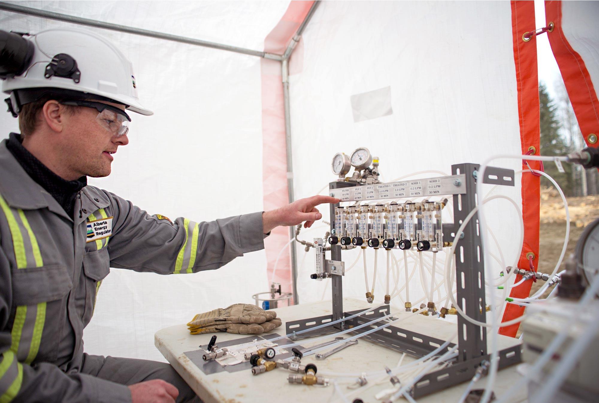 ER field inspector, Dean Thompson, gets ready to collect samples and checks the sampling apparatus