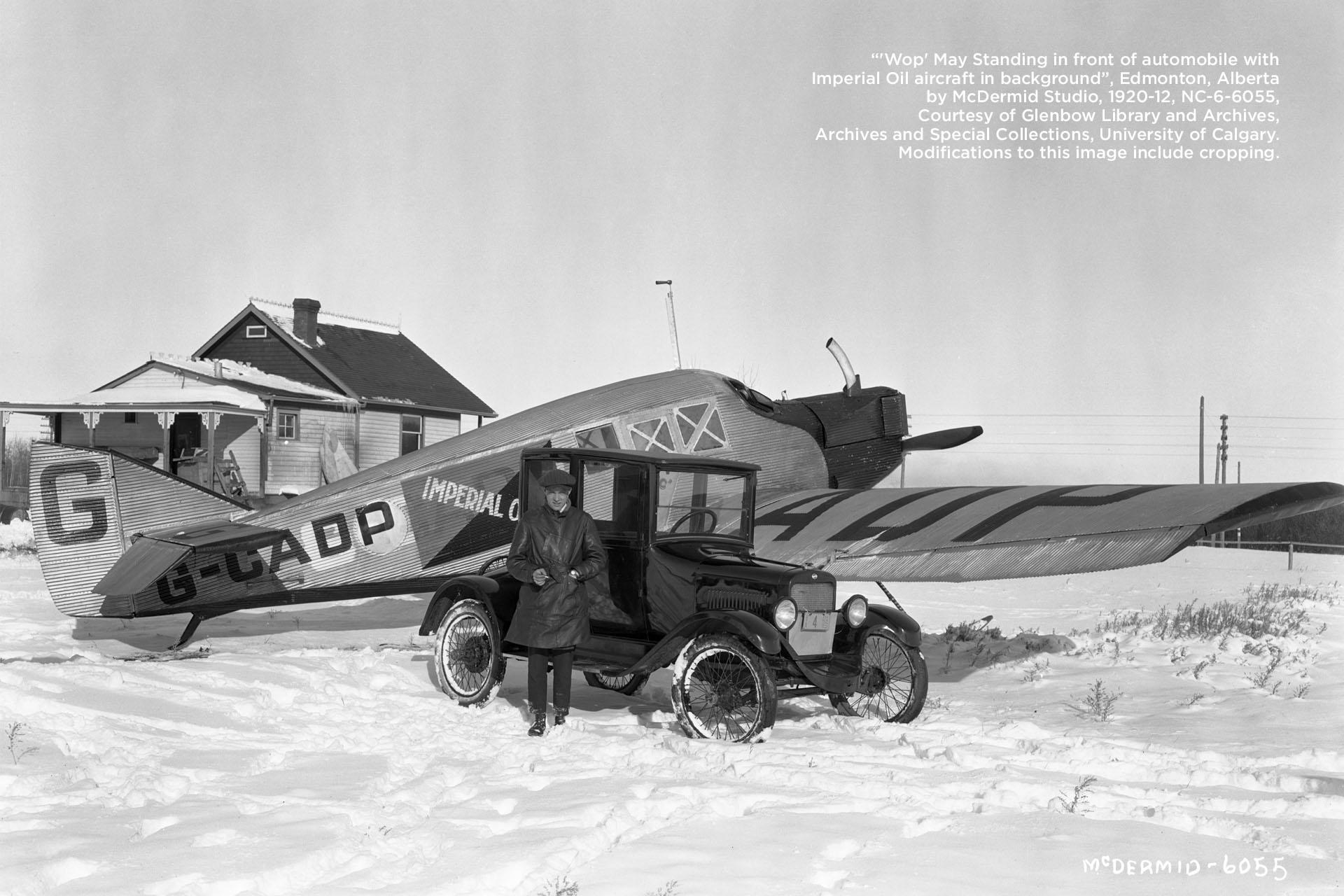 Wilfred &quot;Wop&quot; May in front of automobile